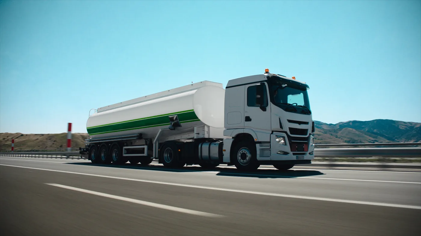 White tanker truck with green livery — ADR hazardous goods transport
